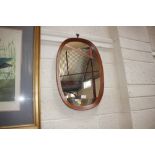 A teak oval framed mirror