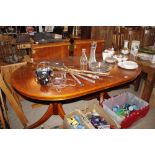 A reproduction yew wood dining table with two extr