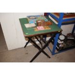 A folding card table with various games