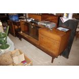 A teak sideboard with sliding glass doors