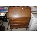 A mahogany bureau fitted three drawers