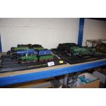 A collection of various model trains on stands
