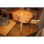 A rustic wooden three legged stool