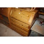 A pine bureau fitted four long drawers