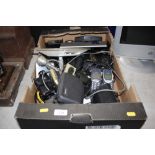 A box containing various binoculars; sat navs etc