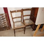 A pair of oak and string seated bedroom chairs