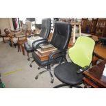 Three swivel office chairs