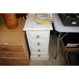 A white painted chest fitted four drawers of narro