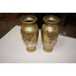 A pair of oriental brass overlaid vases decorated