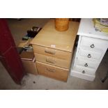 An oak effect three drawer filing chest