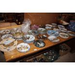 A large collection of various collector's plates t