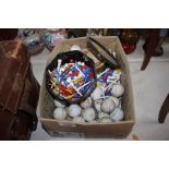 A box of golf balls and tees