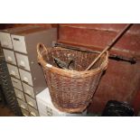 A wicker log basket and contents