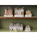 A Leeds pottery model cottage; and four Staffordshire pastille burner cottages (6)