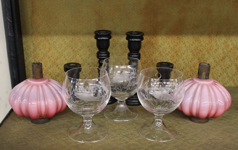 Two pairs of ebony candlesticks; a pair of fine opaque glass oil lamp reservoirs; and three