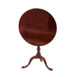 A Georgian mahogany circular snap top table, raised on turned column and tripod base, 65cm dia.