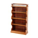 A pair of late Victorian walnut and pitched pine open fronted graduated bookcases, surmounted by