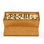 A set of ebony and bone dominoes, in original box