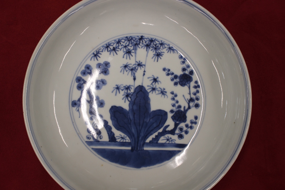 A Chinese blue and white shallow dish, the central field decorated with flowers, 20.5cm dia. six - Image 9 of 13