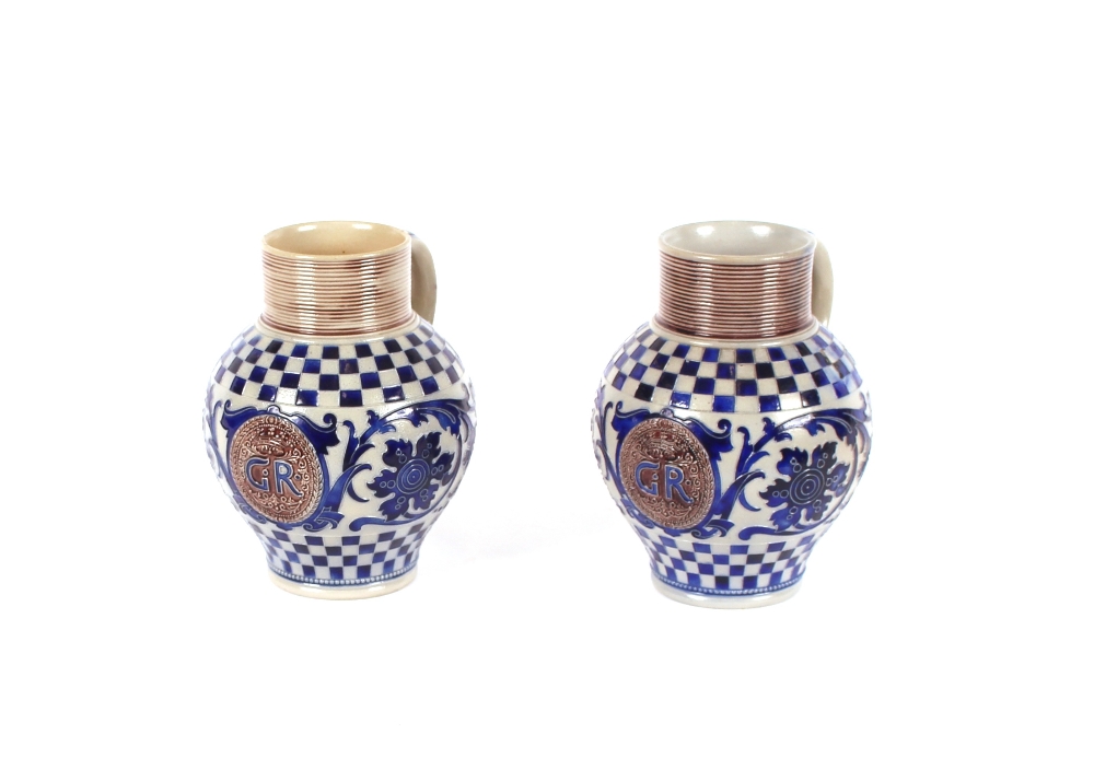 A pair of German salt glazed Westerwald pottery tavern steins, having blue foliate scroll and