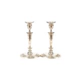 A pair of silver candlesticks, in the 18th Century style, having detachable sconces, reeded