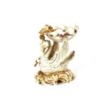 A Samson porcelain salt, in the Meissen style depicting a large shell supported on a swan's back, (