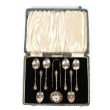 A cased set of Edwardian silver teaspoons, sugar tongs and a sifter spoon, Birmingham 1908