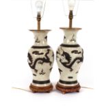 A pair of antique Chinese baluster vases, converted to table lamps, decorated bronzed raised