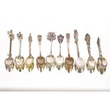 Ten silver and enamel topped spoons, decorated horses, elephants etc.