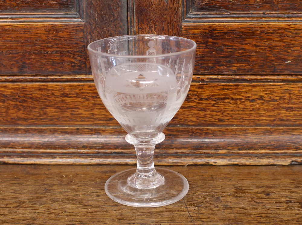 A Masonic etched wine glass, decorated with various symbols, inscribed "INRI" and initialed with a