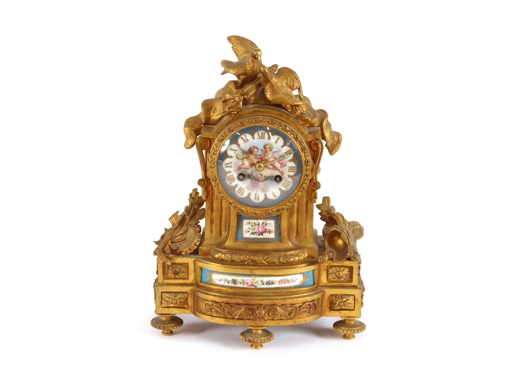 A 19th Century French gilt metal mantel clock, decorated with Sevres style porcelain panels,