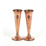 A pair of hammered copper Arts & Crafts design posy vases, 21cm high