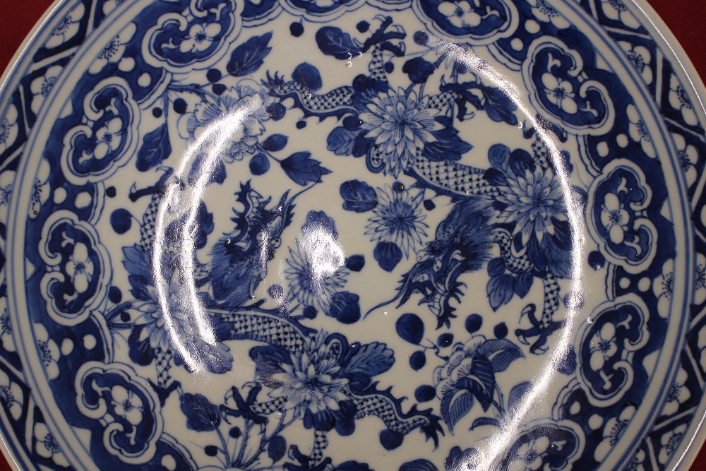 A Chinese blue and white shallow dish, the central field decorated with flowers, 20.5cm dia. six - Image 3 of 13