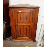 An Antique corner cabinet, the interior shelves enclosed by a single moulded panelled door, 84cm