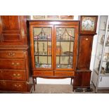 An Edwardian inlaid mahogany china display cabinet, the interior fabric lined shelves enclosed by