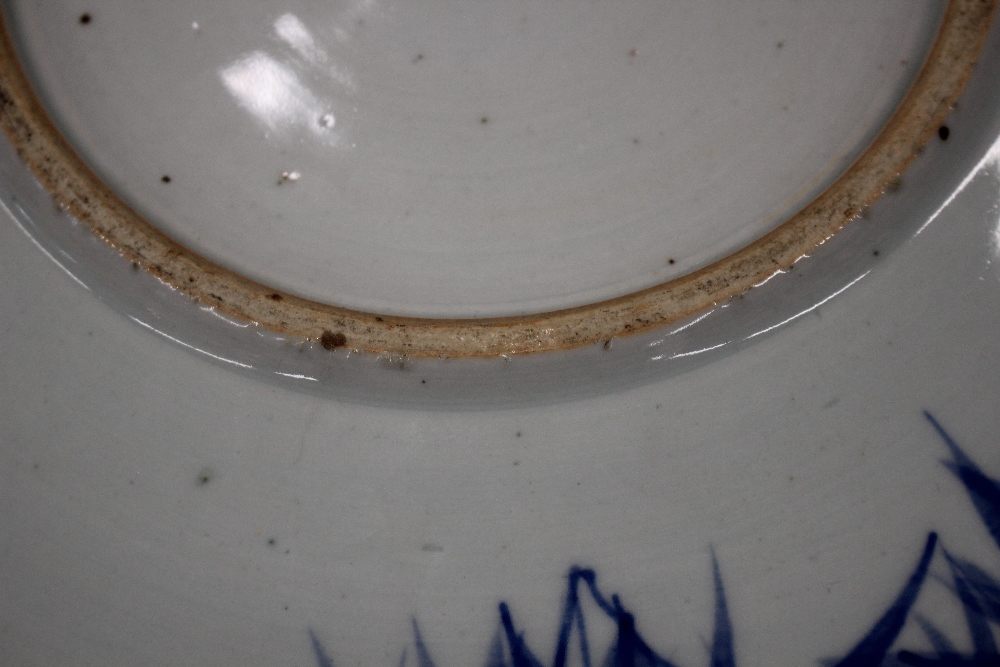 A Chinese blue and white shallow dish, the central field decorated with flowers, 20.5cm dia. six - Image 7 of 13