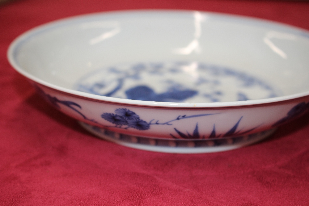 A Chinese blue and white shallow dish, the central field decorated with flowers, 20.5cm dia. six - Image 10 of 13