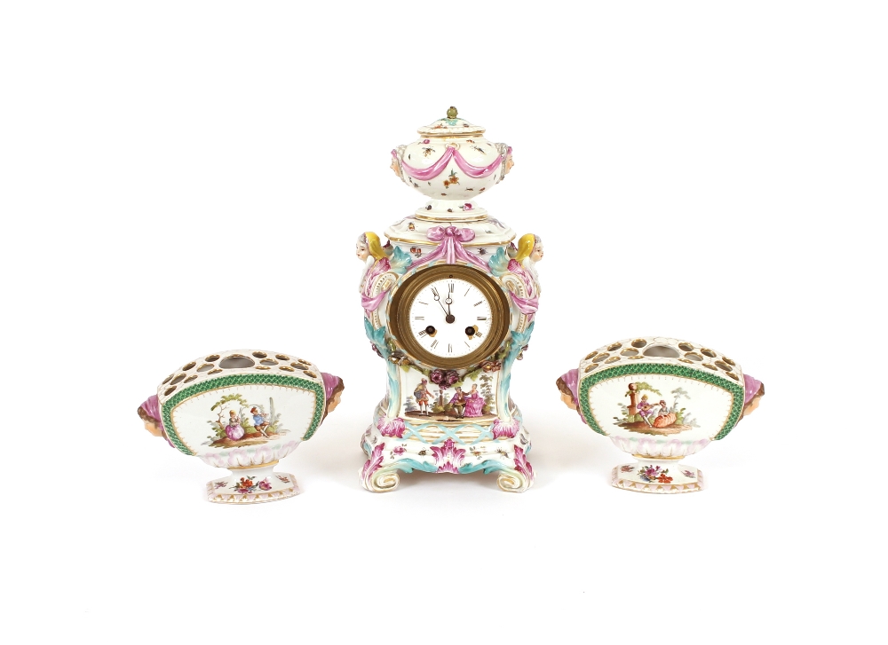 A 19th Century German porcelain clock garniture, decorated with scenes of romantic couples and