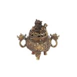 A Chinese bronze censer, with raised decoration of figures and symbols, flanked by beast handles,