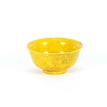 A yellow glazed Chinese porcelain bowl, with raised decoration of dragons and prunus, 16cm dia. x
