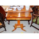 A Regency rosewood and brass inlaid card table, the fold over swivel top raised on a square tapering