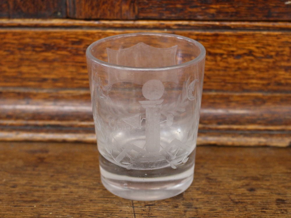 A heavy Masonic etched glass tumbler, decorated with symbols and numbered 900, initialed "G", 8cm