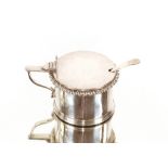 A George V silver drum shaped mustard pot, having gadrooned border blue glass liner and associated