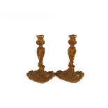 A pair of late 18th / early 19th Century French Ormolu candlesticks, in the Rococo manner