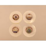 Four finely decorated circular mother of pearl white metal and enamel decorated military place