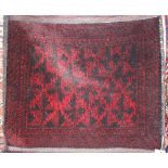 A Teke type bag rug, having stylised decoration, flat weave centre and tasselled ends, 157cm x 71cm