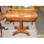 A Victorian rosewood card table, the fold over swivel top raised on a turned column, quatrefoil base