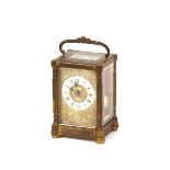 A brass cased striking carriage clock, with white enamel Roman numeral chapter ring and foliate