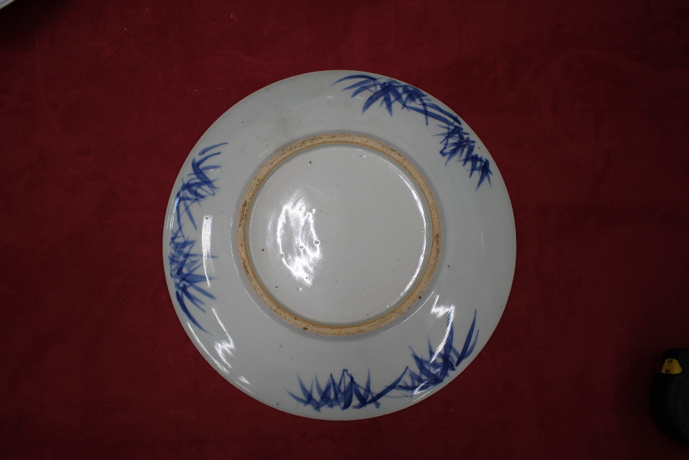 A Chinese blue and white shallow dish, the central field decorated with flowers, 20.5cm dia. six - Image 5 of 13