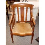 An Edwardian inlaid mahogany tub shaped chair, having upholstered seat, raised on square section